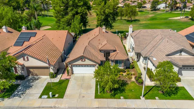 an aerial view of a house with garden space and street view