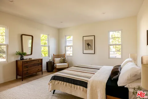 a bedroom with a bed and a windows