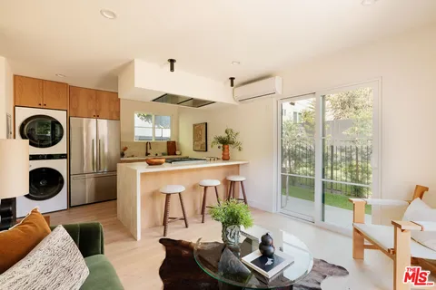 a living room with furniture and a kitchen