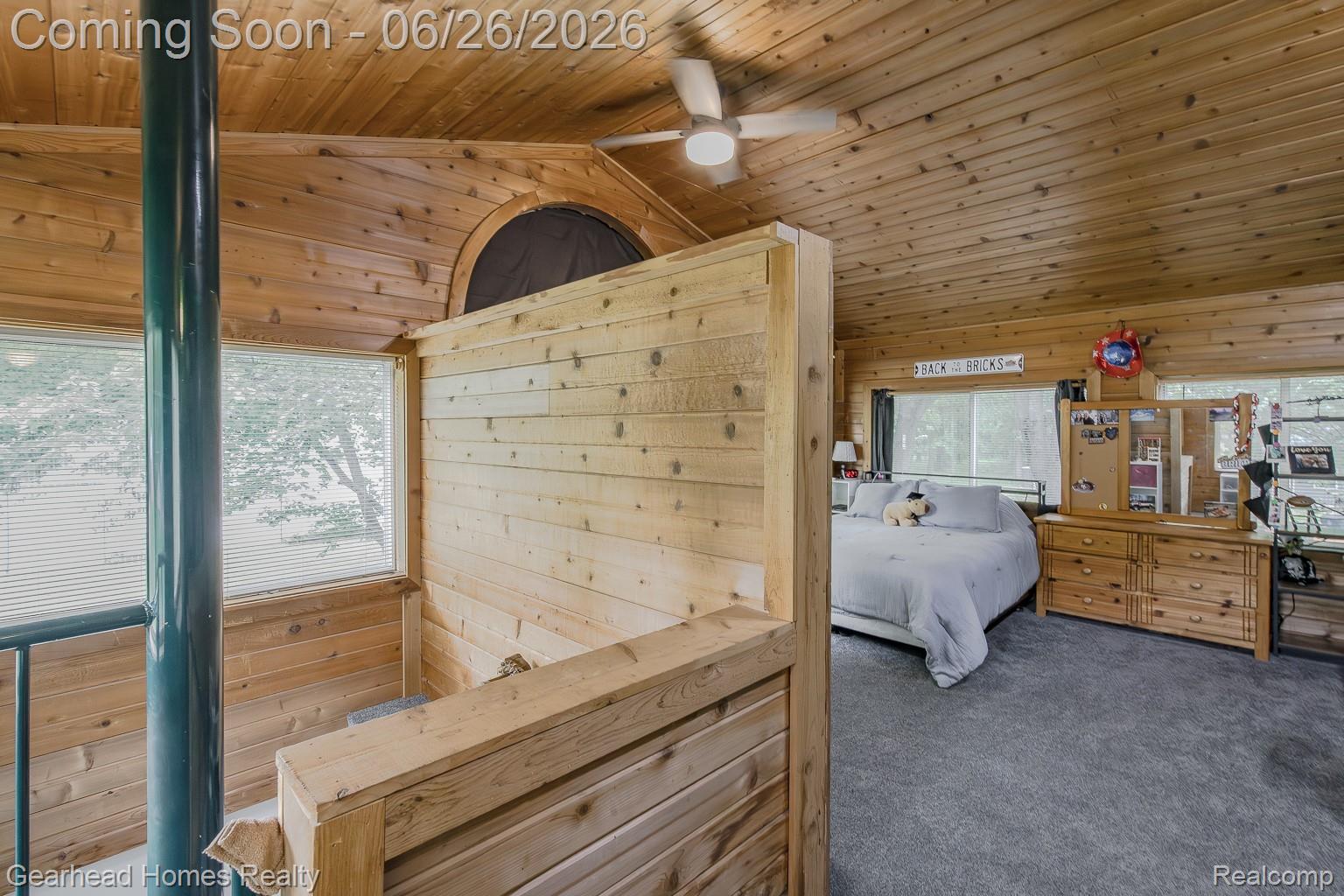 12364 Morrish Road Clio, MI 48420 - Photo 42 of 81 Wood-paneled room featuring a sloped ceiling, ceiling fan, and carpeted flooring