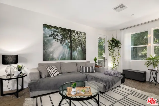 a living room with furniture and a large window