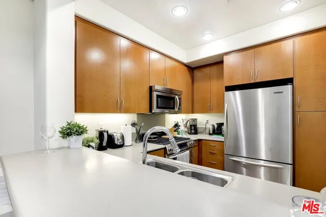 a kitchen with stainless steel appliances a refrigerator and a sink