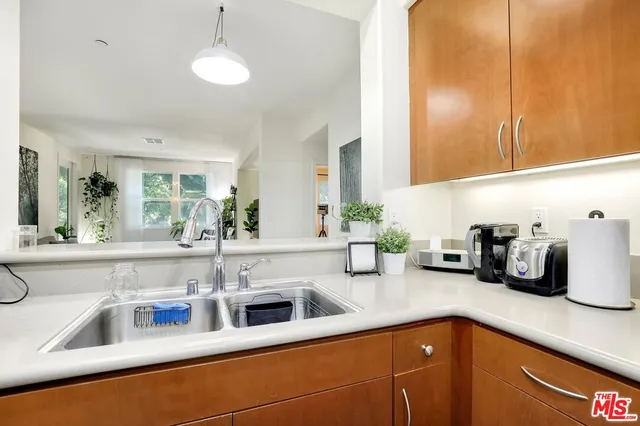 a kitchen with sink and cabinets