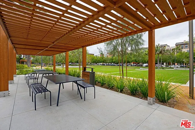 a patio with a patio table and chairs with a big yard