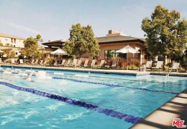 a view of a swimming pool with an outdoor seating