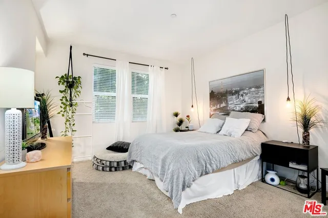 a bedroom with a bed and a table in it