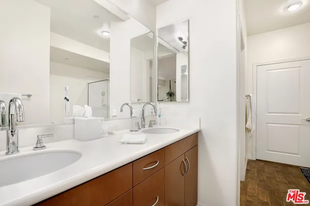 a bathroom with a double vanity sink mirror and double