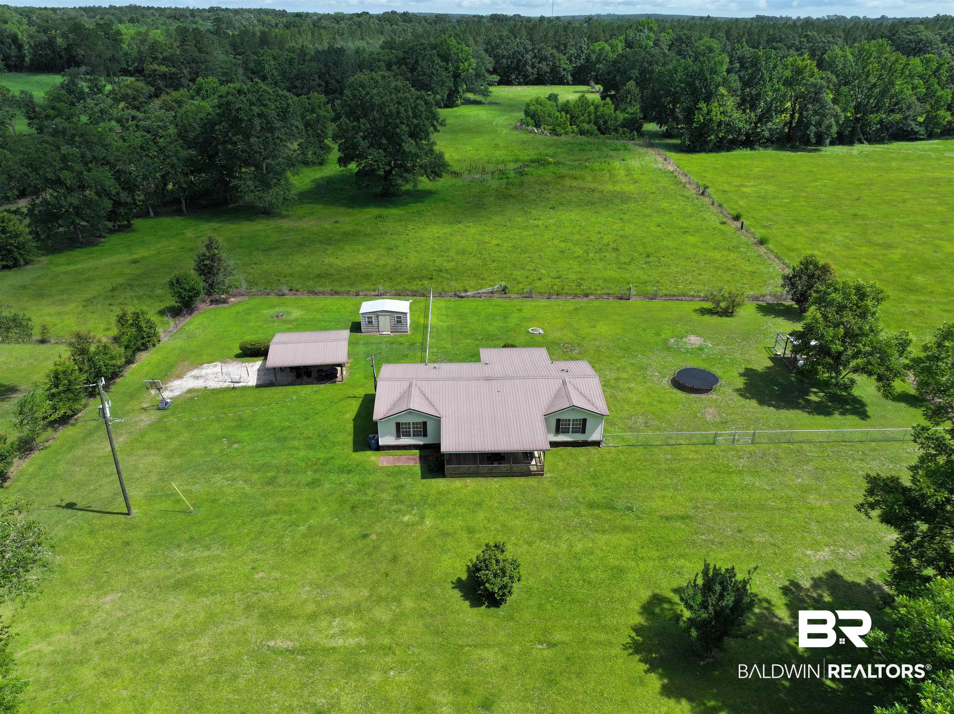 7577 Ridge Road Brewton, AL 36426 - Photo 22 of 24 Aerial view of sparsely populated area with a heavily wooded area