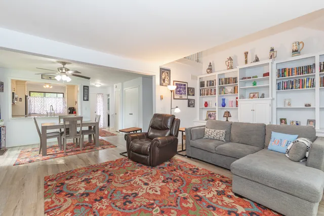 a living room with furniture and a book shelf