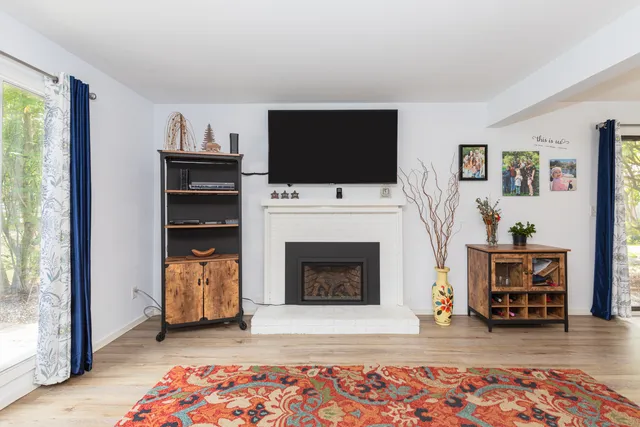 a living room with furniture and a fireplace