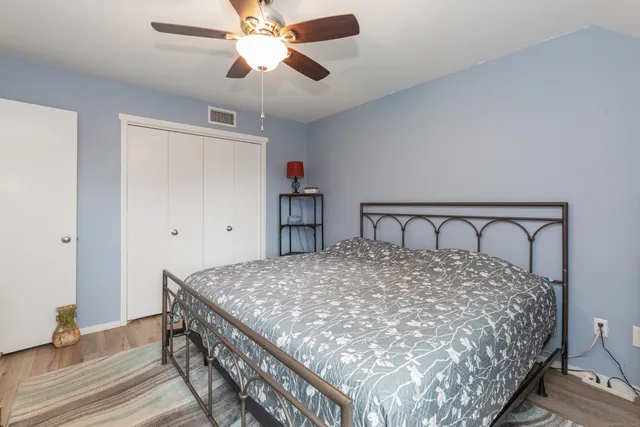 a large bed sitting in a bedroom next to a window