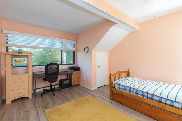 a bedroom with a bed and a desk