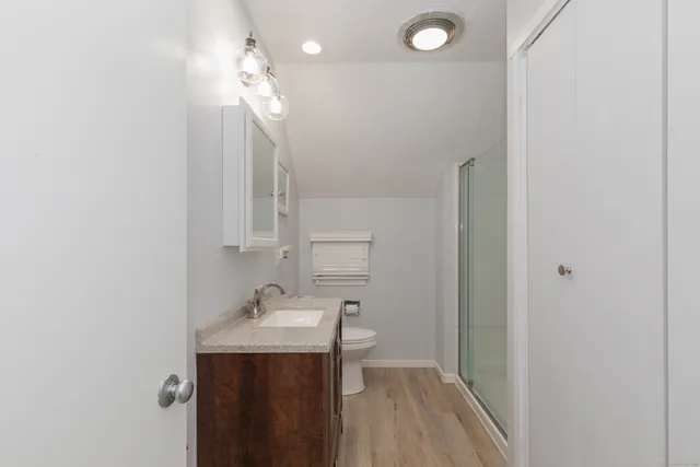 a bathroom with a sink a light fixture and a mirror