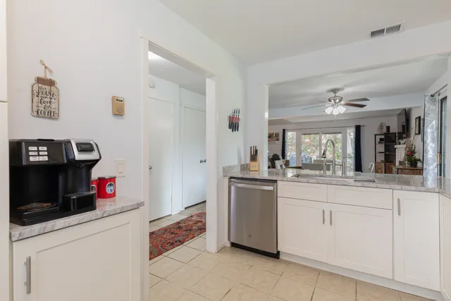 a kitchen with granite countertop a sink and cabinets