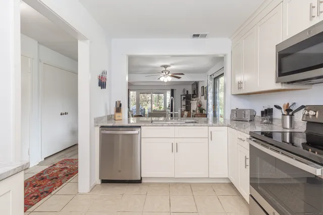 a kitchen with stainless steel appliances granite countertop a sink and cabinets