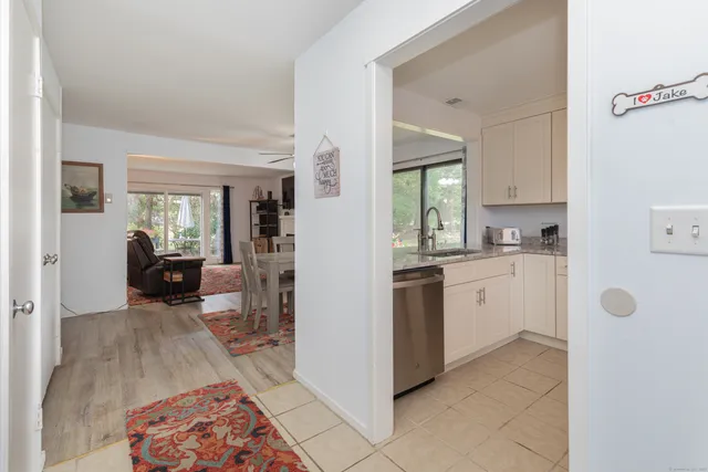 a kitchen with sink and view of living room