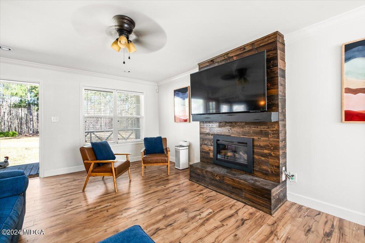 507 Edge Road Forsyth, GA 31029 - Photo 5 of 26 a living room with furniture a flat screen tv and a fireplace