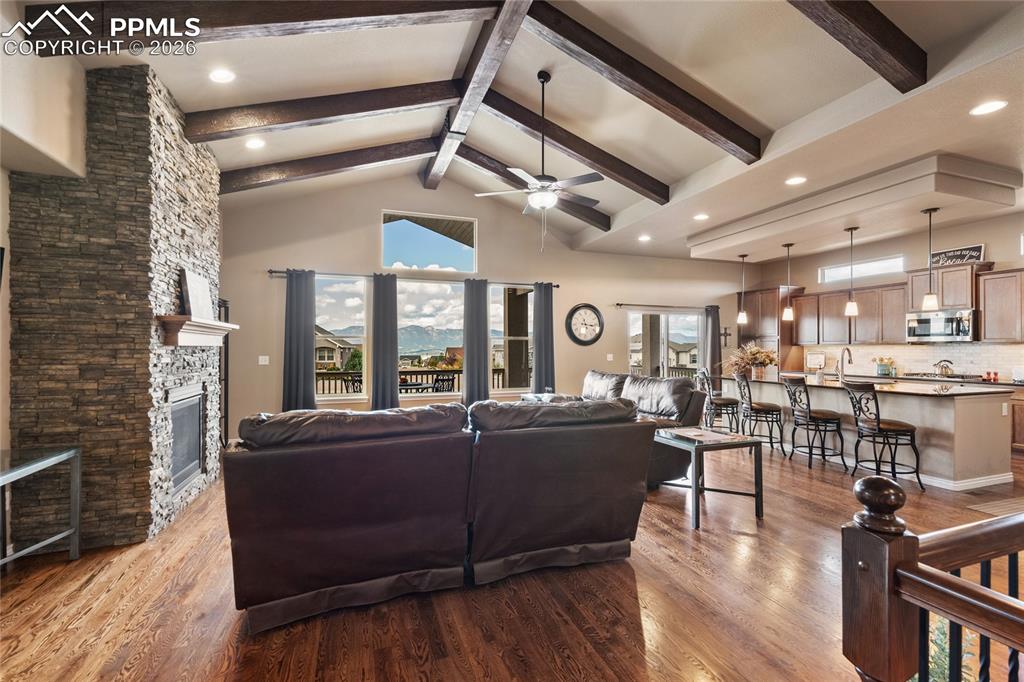 3718 Sky Rim Court Colorado Springs, CO 80908 - Photo 13 of 49 Vaulted ceiling with accent beams and a gas fireplace.