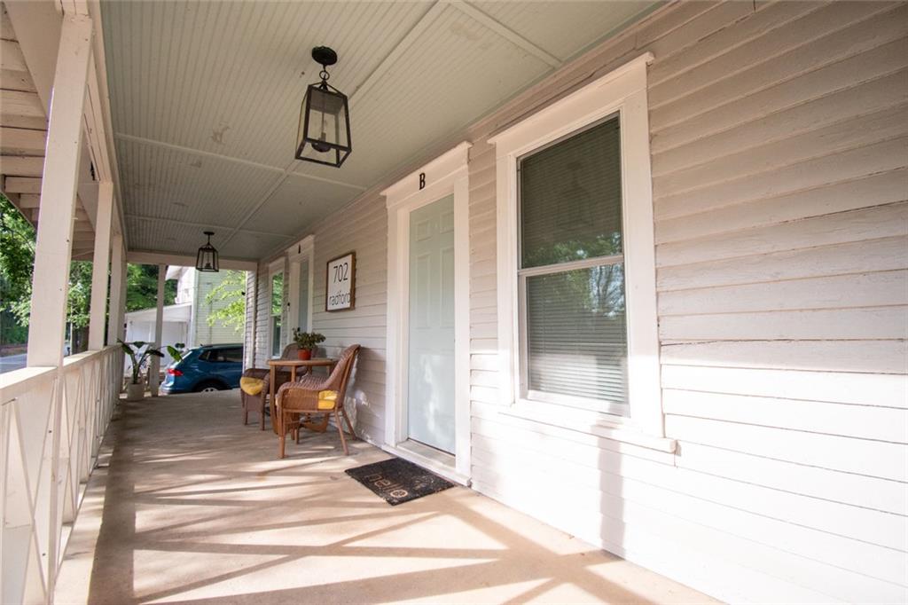 702 Radford Street Monroe, GA 30655 - Photo 23 of 49 a view of a patio with table and chairs and wooden floor