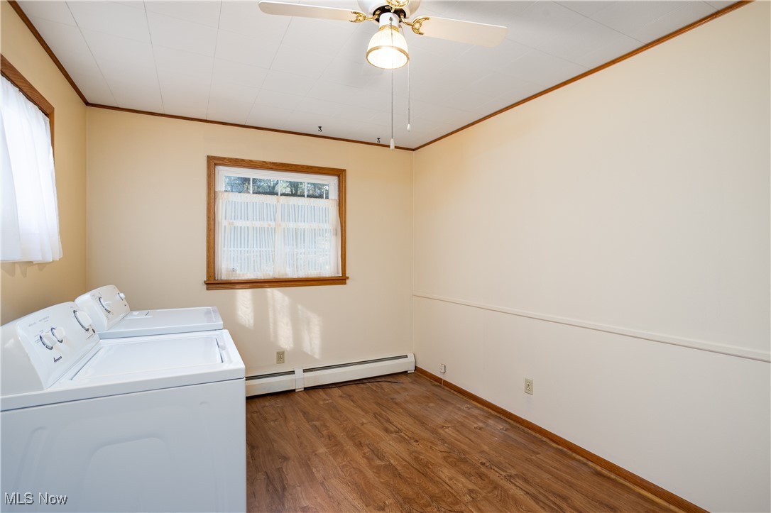 7384 South Cleveland Massillon Road Clinton, OH 44216 - Photo 28 of 35 Laundry area featuring crown molding, hardwood / wood-style floors, a baseboard radiator, washer and dryer, and ceiling fan