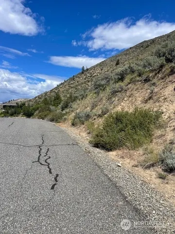 a view of a large building with mountains in the background