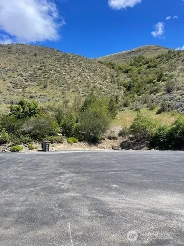 a view of a dry yard with mountains in the background