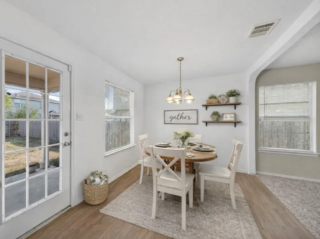 a view of a dining room with furniture window and wooden floor