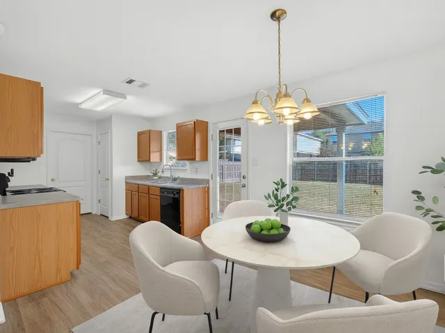 a dining room with furniture and window