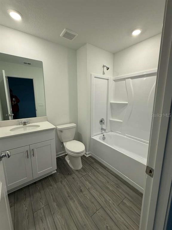 8325 Southwest 42nd Circle Ocala, FL 34476 - Photo 12 of 23 a bathroom with a bathtub sink mirror vanity and toilet