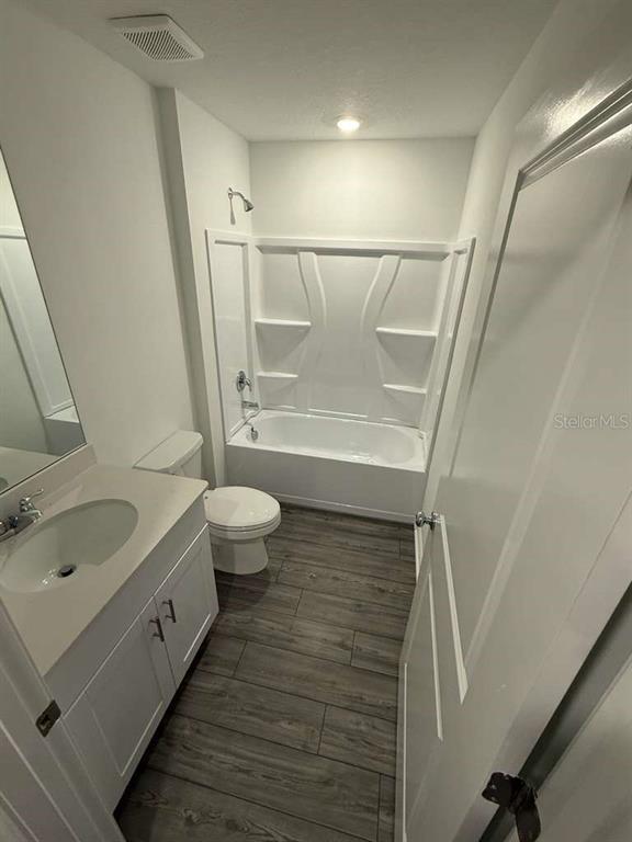 8325 Southwest 42nd Circle Ocala, FL 34476 - Photo 8 of 23 a bathroom with a sink a toilet and a large mirror