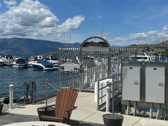 a view of a patio with table and chairs under an umbrella