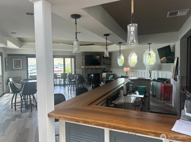 a bathroom with a sink mirror and painting on the wall