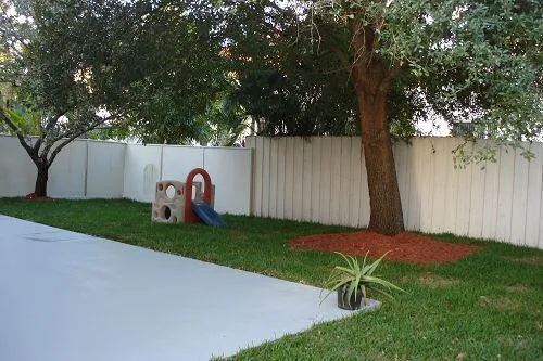 a garden with trees in the background