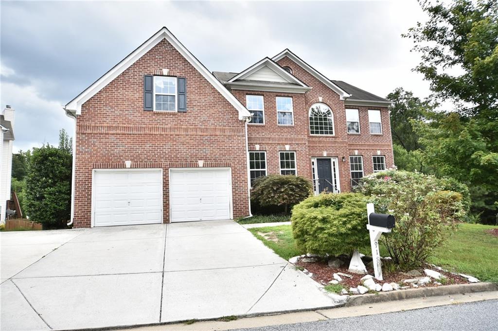 918 Queensbrooke Way Southeast, Unit 918 Mableton, GA 30126 - Photo 1 of 1 a front view of a house with a yard and garage