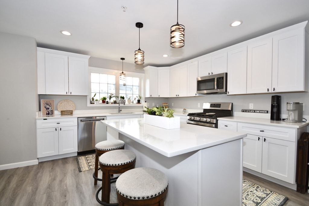 550 Spring Street, Unit 2 Fall River, MA 02721 - Photo 5 of 13 a kitchen with a sink stainless steel appliances and white cabinets