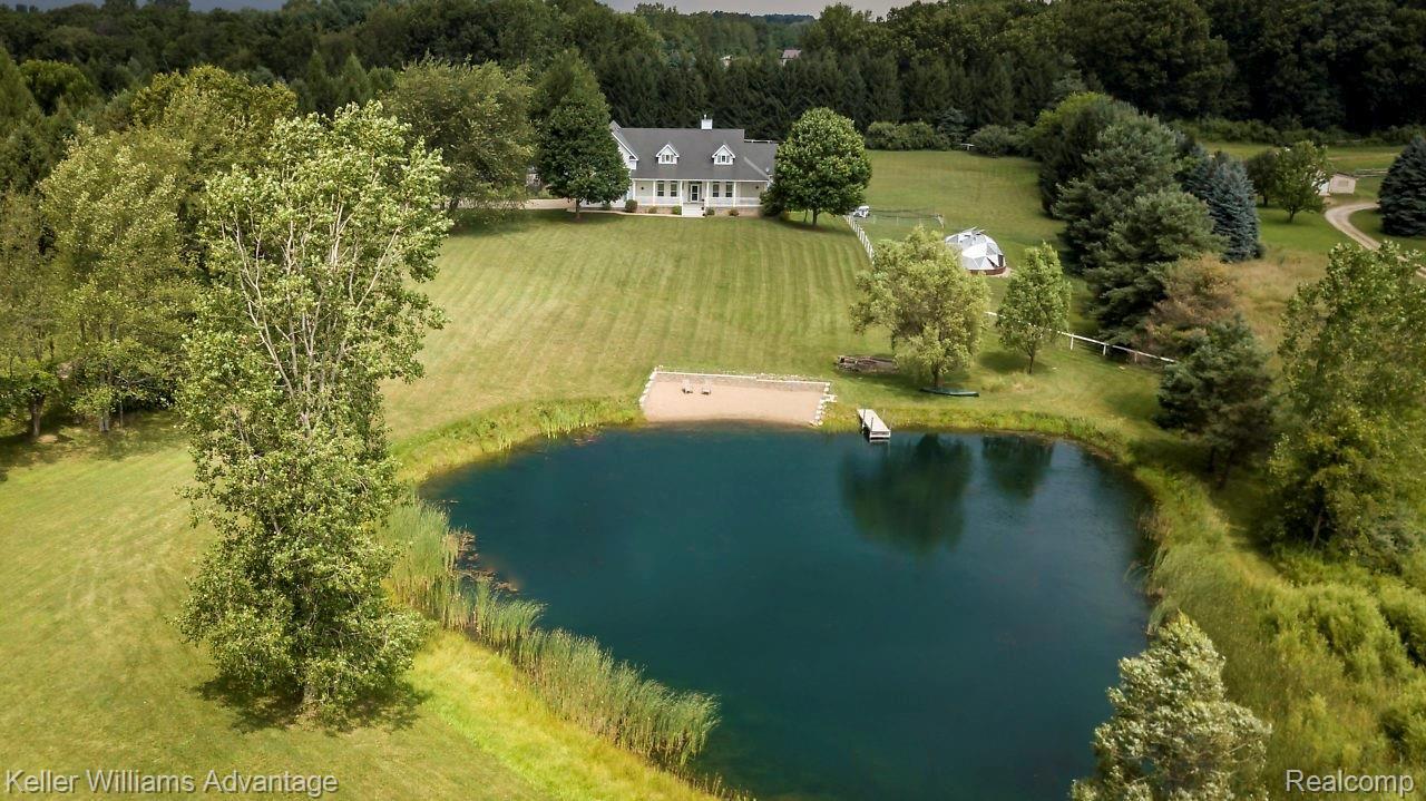4558 Vines Road Howell, MI 48843 - Photo 32 of 46 Relax by your own pond with beach, dock and sitting area