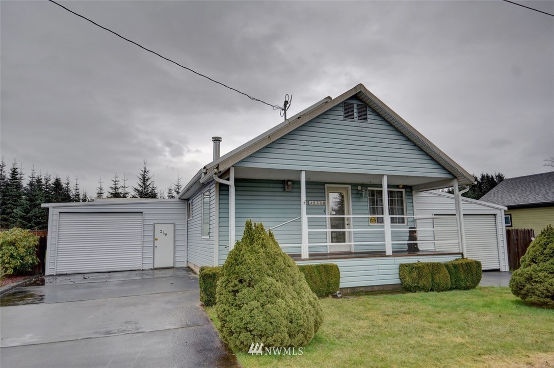 238 Stowell Road Salkum, WA 98582 - Photo 1 of 26 a front view of a house with a garden and plants