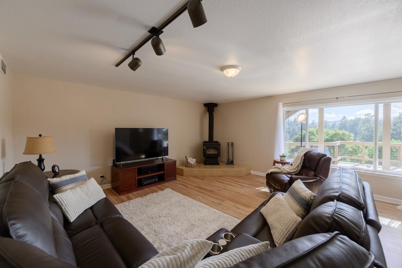 155 Rabbits Run Road Santa Cruz, CA 95060 - Photo 73 of 113 a living room with furniture a flat screen tv and a large window