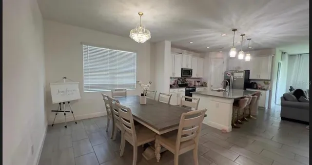 a view of a dining room with furniture and chandelier