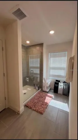 a bathroom with a double vanity sink toilet mirror and shower