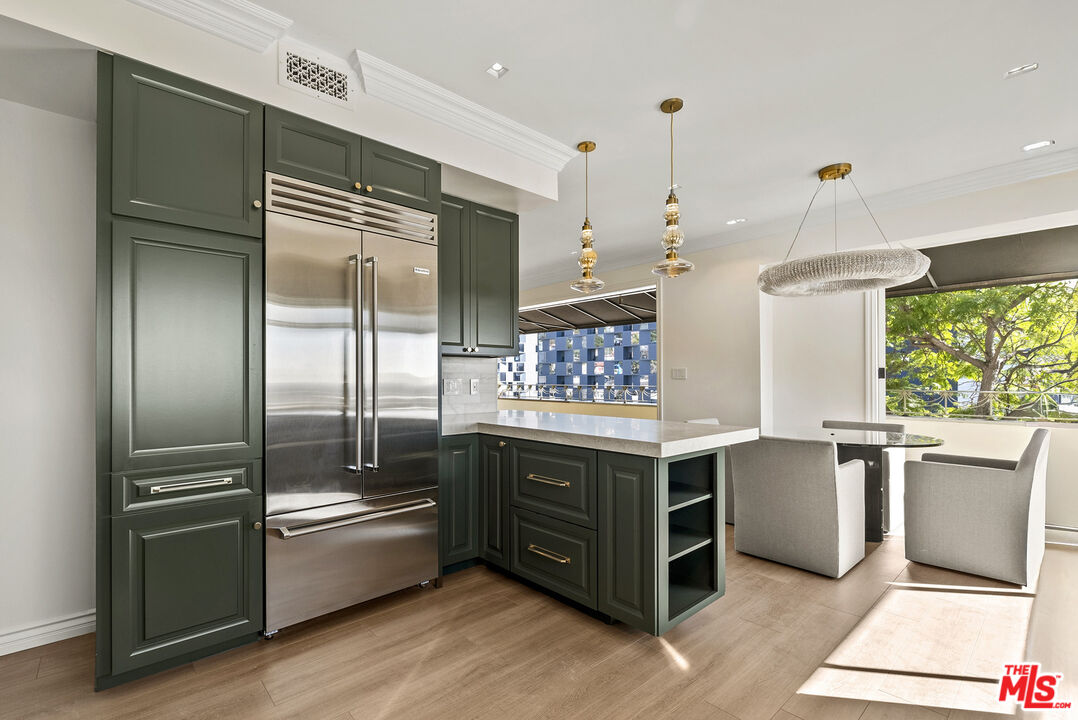 1326 Londonderry View Drive, Unit 4 Los Angeles, CA 90069 - Photo 12 of 29 a kitchen with a refrigerator and countertop