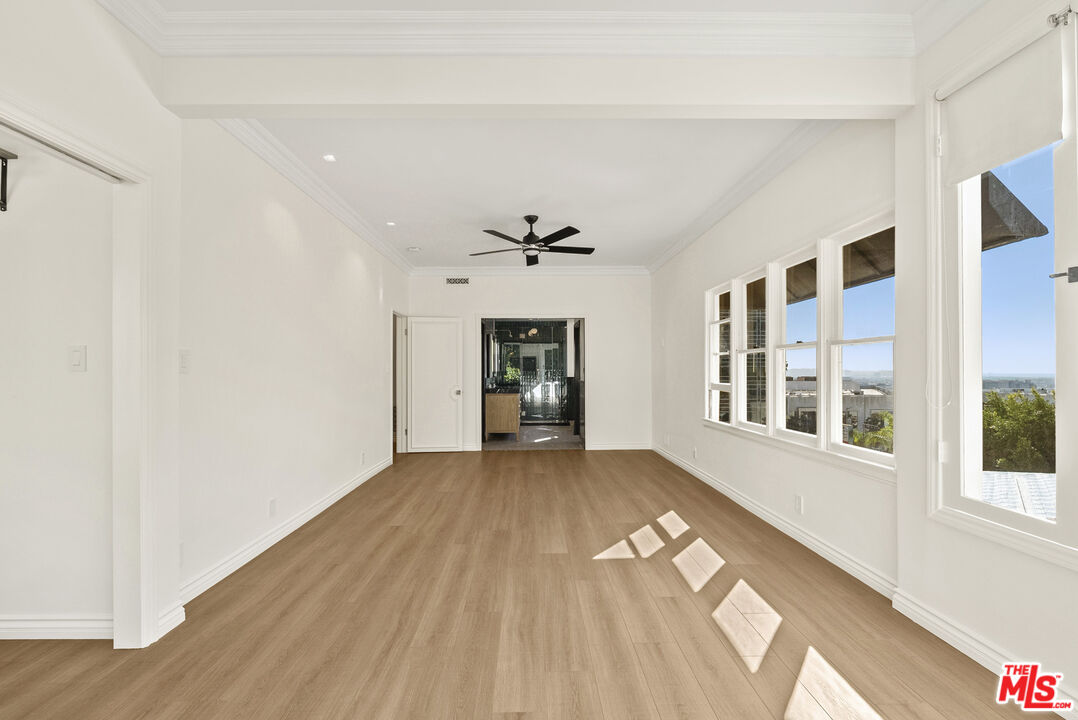 1326 Londonderry View Drive, Unit 4 Los Angeles, CA 90069 - Photo 18 of 29 a view of an empty room with wooden floor and a window