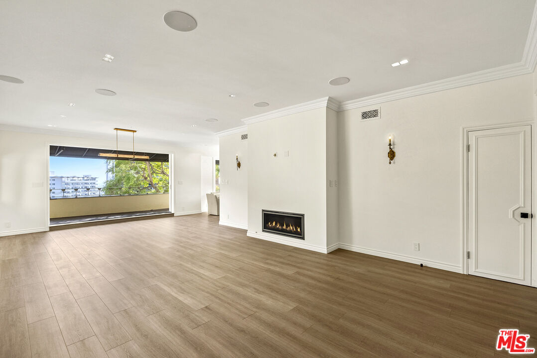 1326 Londonderry View Drive, Unit 4 Los Angeles, CA 90069 - Photo 2 of 29 a view of a livingroom with wooden floor and a ceiling fan