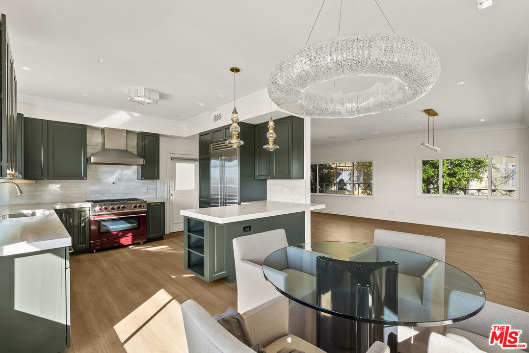 1326 Londonderry View Drive, Unit 4 Los Angeles, CA 90069 - Photo 8 of 29 a kitchen with stainless steel appliances granite countertop a sink and a refrigerator