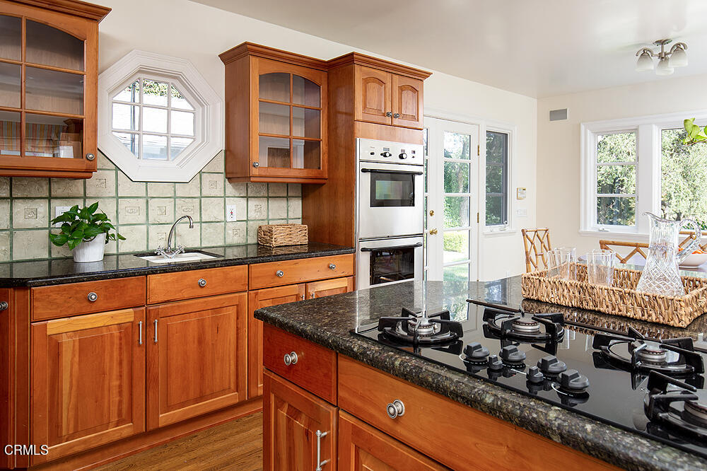 141 Sierra View Road Pasadena, CA 91105 - Photo 12 of 38 a kitchen with stainless steel appliances a stove and a sink