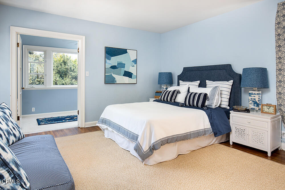 141 Sierra View Road Pasadena, CA 91105 - Photo 21 of 38 a bedroom with a bed and a painting on the wall