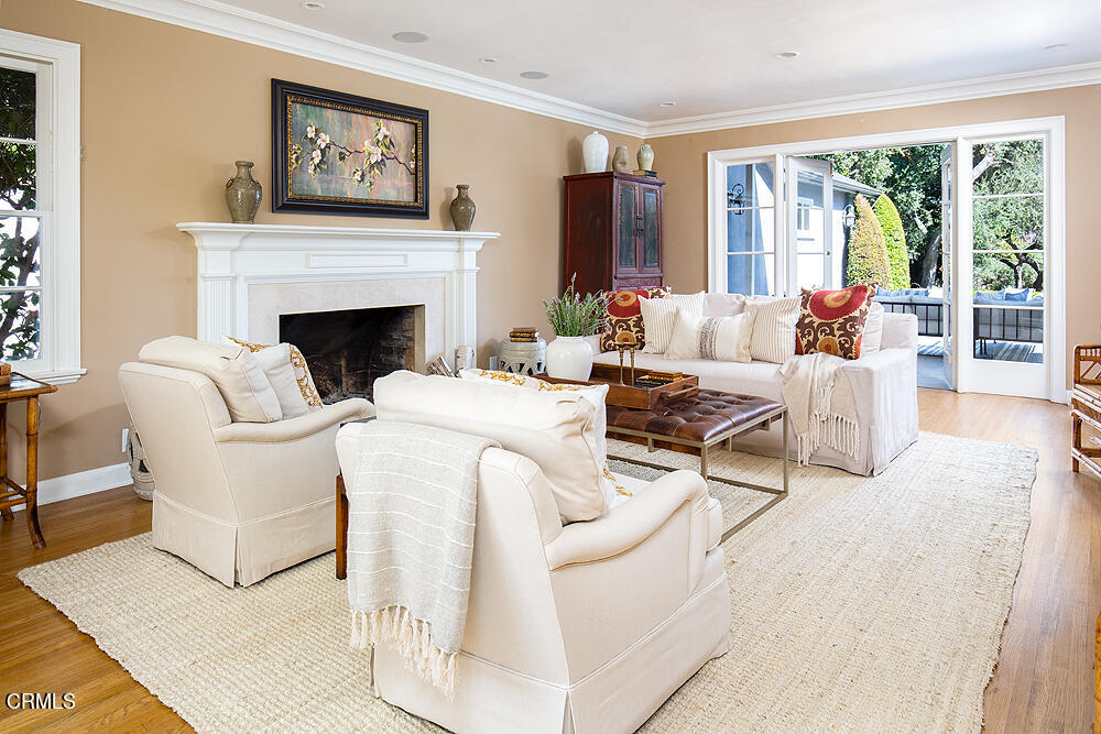 141 Sierra View Road Pasadena, CA 91105 - Photo 5 of 38 a living room with furniture a large window and a fireplace