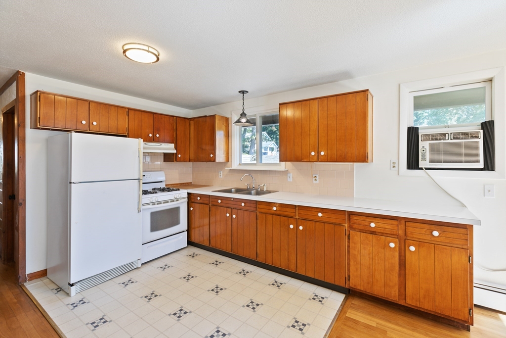 60 Park Road Charlton, MA 01507 - Photo 11 of 30 a kitchen with stainless steel appliances a refrigerator a sink and white cabinets