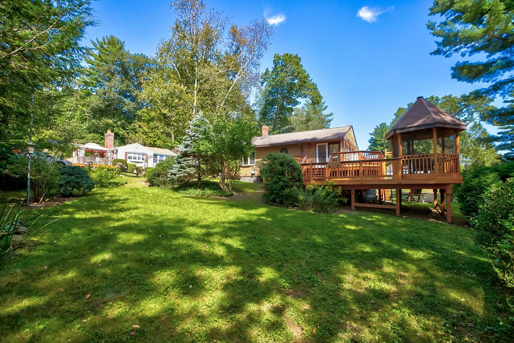 60 Park Road Charlton, MA 01507 - Photo 22 of 30 a backyard of a house with table and chairs plants and large tree
