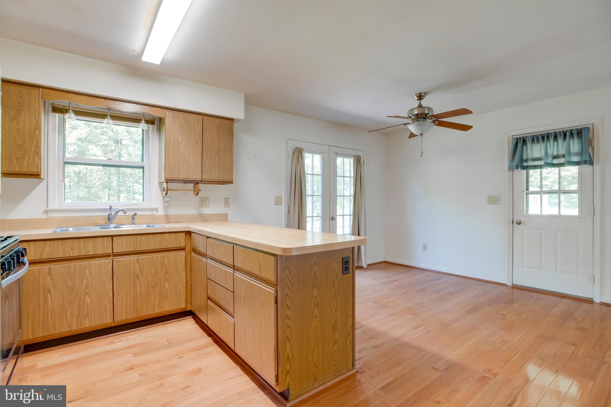 803 Weaver Hollow Road Banco, VA 22711 - Photo 7 of 67 a kitchen with a sink cabinets appliances and a window